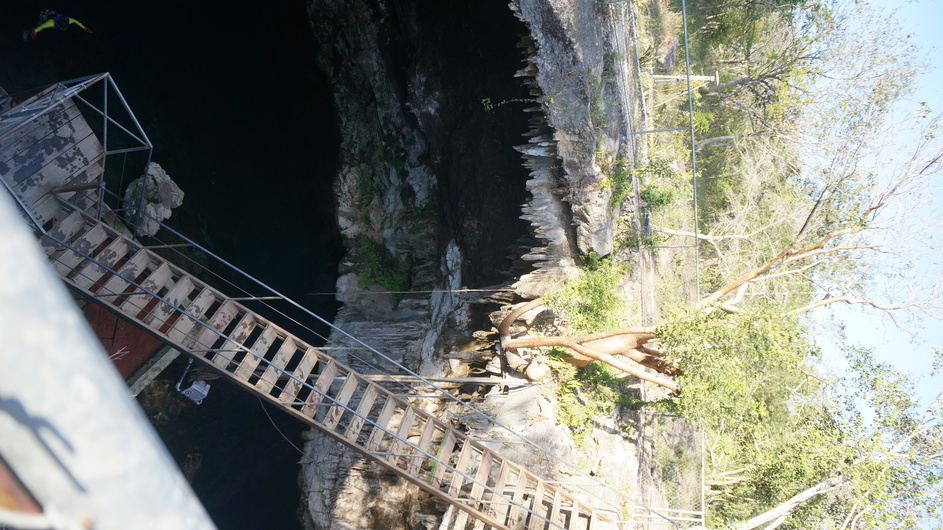 GPS in background behind fence shown located over cenote cavern